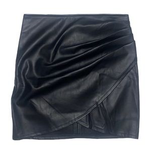 Mini black faux leather skirt with soft lining and side pleating.